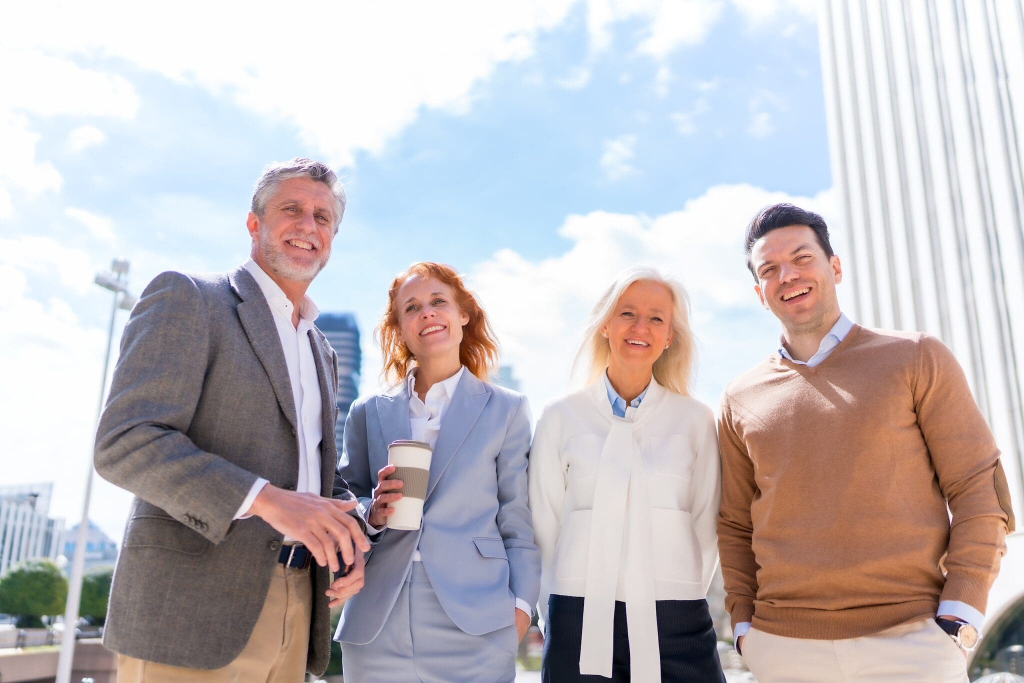 Portrait and looking at a tablet one morning smiling. Group executives or businessmen and businesswoman in a business area